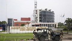 Gabonese soldiers stand in front of the headquarters of the national broadcaster in Libreville on January 7, 2019, after a failed coup. Gabon shut down the internet and broadcasting services following the coup attempt. Credit: CPJ/AFP/Steve Jordan.
