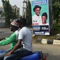 A campaign poster for Nigeria's incumbent president and candidate Muhammadu Buhari and his Vice-President Yemi Osinbajo, pictured in Lagos, on January 4. Credit: AFP/Pius Utomi Ekpei. Source: Committee to Protect Journalists (CPJ).
