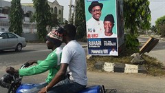 A campaign poster for Nigeria's incumbent president and candidate Muhammadu Buhari and his Vice-President Yemi Osinbajo, pictured in Lagos, on January 4. Credit: AFP/Pius Utomi Ekpei. Source: Committee to Protect Journalists (CPJ).