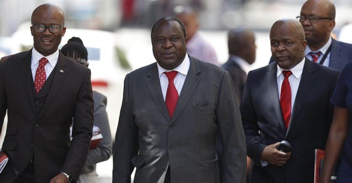 South Africa’s Finance Minister Tito Mboweni (centre) arrives to deliver the mid-term budget statement to Parliament. EPA-EFE/Nic Bothma