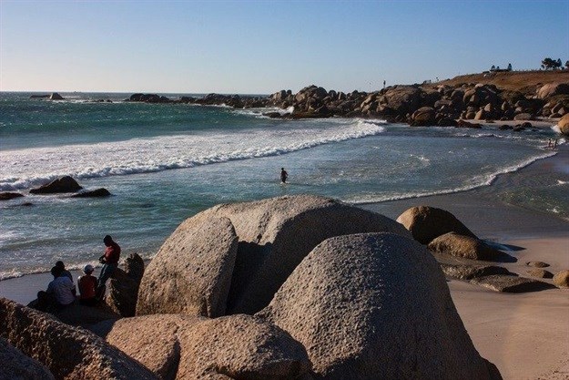 Despite a near gale-force south-easterly, swimmers and picnickers enjoy a late afternoon at Glen beach in Camps Bay. The headland in the background is Maiden’s Cove, which is little more than 700 metres from where millions of litres of sewage is pumped into the sea daily. Water quality on a day such as this, with strong offshore winds and no recent rainfall, is likely to meet quality guidelines. However, after rain, which comes with onshore winds, water quality often fails minimum guidelines for recreational use. Photo: Steve Kretzmann/WCN