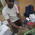 An electoral worker prepares identity card and biometric verification readers, at the offices of the Independent National Electoral Commission in Kano, northern Nigeria, on February 14, 2019. CPJ joined a call for Nigeria to ensure that internet and social media services remain connected during the upcoming elections. Credit: CPJ/AP Photo/Ben Curtis.