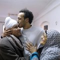 Egyptian photojournalist Mahmoud Abou Zeid, also known as Shawkan, center, is hugged by his parents at his home in Cairo, Egypt, Monday, March 4, 2019. Shawkan was released after five years in prison. Credit: CPJ/AP Photo/Amr Nabil.