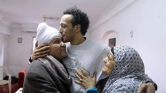 Egyptian photojournalist Mahmoud Abou Zeid, also known as Shawkan, center, is hugged by his parents at his home in Cairo, Egypt, Monday, March 4, 2019. Shawkan was released after five years in prison. Credit: CPJ/AP Photo/Amr Nabil.