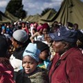People queue in makeshift camps following past threats of xenophobic attacks in South Africa. Today, rescinded health department memos requesting foreigners pay in full for healthcare have sparked a national debate. (Fredrik Lemeryd)