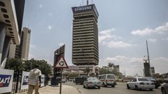 A man walks down a street in central Lusaka, the capital of Zambia, on November 12, 2014. Prime TV, an independent station in Zambia, was recently suspended by the country's media regulator. Credit: CPJ/Gianluigi Guercia/AFP.