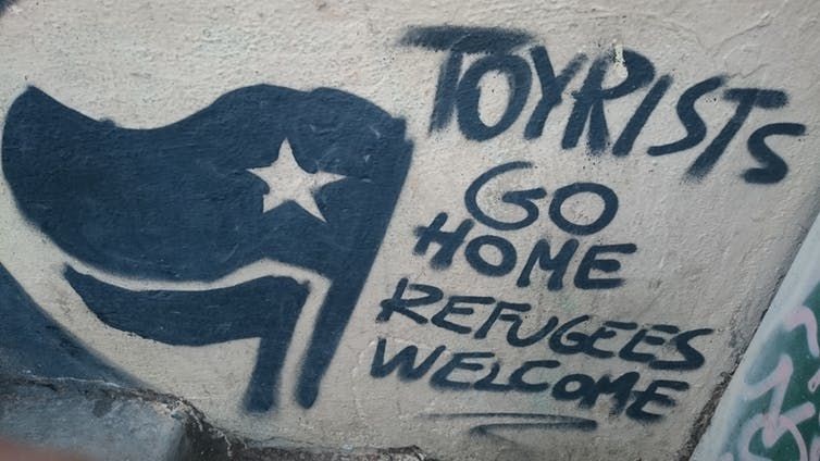 Tourists go home. Refugees welcome. ,
