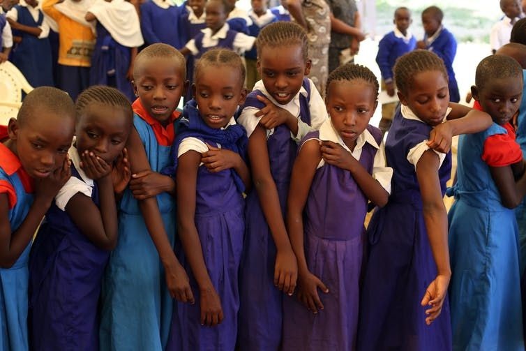 Kenyan schoolgirls looking at a friend who is getting vaccinated against HPV which causes cervical cancer. EPA/Karel Prinsloo/GAVI