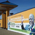 A banner of Tanzanian President John Magufuli hangs on a wall around a tanzanite mine, in April 2018. CPJ and other organizations are calling on the Human Rights Council to address a crackdown on journalists, human rights defenders, and other groups in the country. Credit: CPJ/AFP/Joseph Lyimo.