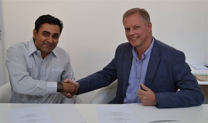 Prabdeep Bajwa (left) shakes hands with Jacques Taylor (right) after they signed the MoU
