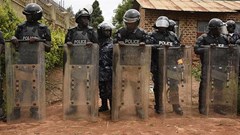Ugandan police officers are seen in Kampala on April 23, 2019. Police recently arrested Joseph Kabuleta for allegedly posting “offensive communication against the person of the President” online. Credit: CPJ/AFP/Isaac Kasamani.