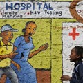 Women walk past a mural painted to raise awareness on HIV and AIDS in Kibera slum in Nairobi, Kenya. EPA/Dai Kurokawa