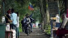 A man rides a motorcycle as young people of the Sidama ethnic group, the largest in southern Ethiopia, celebrate at Hawassa city over plans by local elders to declare the establishment of a breakaway region for the Sidama, in Awasa, July 15, 2019. Authorities arrested three media workers from the Sidama Media Network on July 18. Credit: CPJ/AFP/Michael Tewelde.