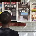 A man looks at newspaper front pages in Dakar, on February 25, 2019, one day after Senegal's presidential elections. Senegalese authorities arrested critical journalist Adama Gaye on July 29. Credit: CPJ/AFP/Seyllou.