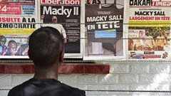A man looks at newspaper front pages in Dakar, on February 25, 2019, one day after Senegal's presidential elections. Senegalese authorities arrested critical journalist Adama Gaye on July 29. Credit: CPJ/AFP/Seyllou.