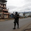A Cameroonian elite Rapid Intervention Battalion member walks along an empty street in the city of Buea in Cameroon's Anglophone southwest region on October 4, 2018. Cameroon’s military detained pidgin news anchor Samuel Wazizi on August 2, 2019, in Buea. Credit: CPJ/Reuters/Zohra Bensemra.
