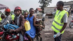 A health worker spreading disinfectant at a health checkpoint in Goma, DRC. Patricia Martinez/EPA-EFE