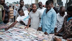 People look at front pages at a newspaper stand in Port Harcourt, after Nigeria's presidential election results were announced on February 27, 2019. Nigerian police beat two Inspiration FM journalists after covering a protest in Uyo, in Akwa-Ibom State, on September 24, 2019. Credit: CPJ/AFP/Yasuyoshi Chiba.