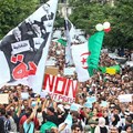 Algerian demonstrators chant and wave their country's national flag as they take part in an anti-government protest in the capital Algiers on October 15, 2019. Authorities have detained at least three more journalists in recent days. Credit: CPJ/AFP.