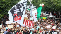 Algerian demonstrators chant and wave their country's national flag as they take part in an anti-government protest in the capital Algiers on October 15, 2019. Authorities have detained at least three more journalists in recent days. Credit: CPJ/AFP.
