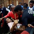 Police officers detain Sahara Reporters journalist Victor Ogungbenro during a protest in Lagos, Nigeria, on August 5, 2019. Staff at the online newspaper report sustained harassment targeting them and their website. Credit: CPJ/AP/Sunday Alamba.