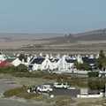 The view looking east across the West Coast with the village of Paternoster in the foreground. The recently approved Boulders Wind farm will stand on the hills in the background, directly in this view. Photo: John Yeld