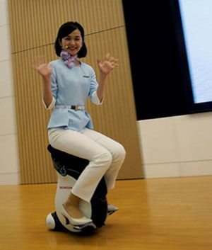 A Honda employee demonstrates a personal mobility device developed by the car maker. Franck Robichon/EPA