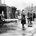 The St Louis Red Cross Motor Corps on duty with mask-wearing women holding stretchers at the backs of ambulances during the global flu epidemic, St Louis, Missouri, October 1918.
Photo by Underwood Archives/Getty Images