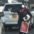 A vendor distributes newspapers wearing a face mask as a preventive measure against the spread of the Covid-19 coronavirus in Nairobi, Kenya. Simon Maina/AFP via Getty Images