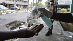 A visitor sanitises hands before entering a state hospital at Yaba, Lagos. Hospitals like this are likely to suffer power cuts as lock down force Nigerians to stay at home and consume more power.
Photo by Pius Utomi Ekpei/AFP via Getty Images