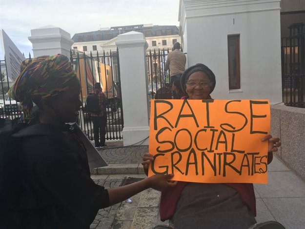 Social grant recipients rally outside parliament in Cape Town calling for increases to grant rates in 2017. Photo by Christopher Webb