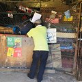 Justice Rapapule serving a client at his spaza shop in Tsakane. Photo: Kimberly Mutandiro