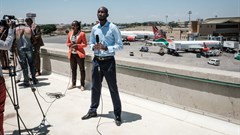 TV reporters prepare for a live broadcast during a strike by airline workers in Nairobi. Yasuyoshi Chiba/AFP via Getty Images.