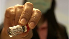 A researcher holds a Covid-19 mRNA vaccine at the National Primate Research Center of Chulalongkorn University in Thailand. Chaiwat Subprasom/SOPA Images/LightRocket via Getty Images