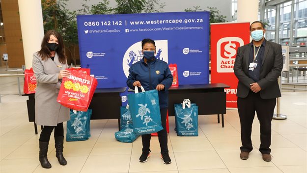 From left Wendy van Rensburg from the Shoprite Group, Dr Nomafrench Mbombo, Western Cape MEC for Health and Theo Abrahams, CEO of the Cape Town Convention Centre, in the foyer at the CTICC, where retailer recently donated 250 care packs which include warm blankets to the Western Cape Department of Health.