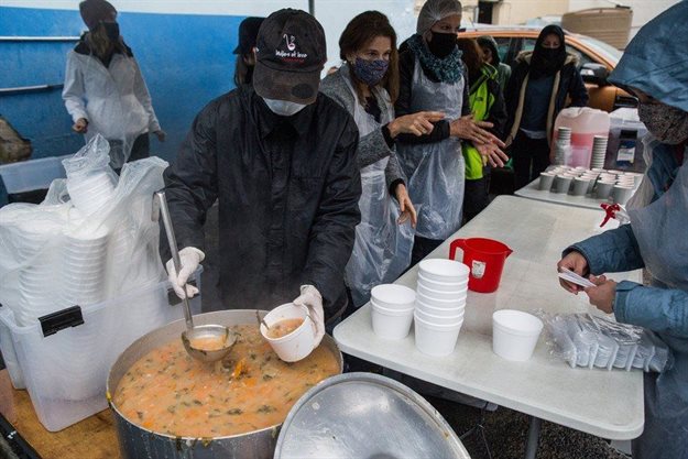 A group of volunteers prepares to give soup to homeless people at the Hope Exchange. Everyone coming to collect has to wear masks and have their hands sanitised at the entrance. If they don’t have a mask, one is given to them.