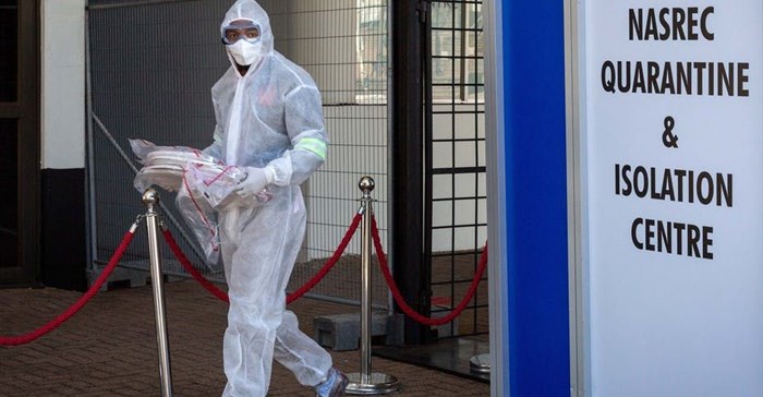 A healthcare worker in a protective suit is seen at a quarantine and isolation centre in Johannesburg, South Africa.
