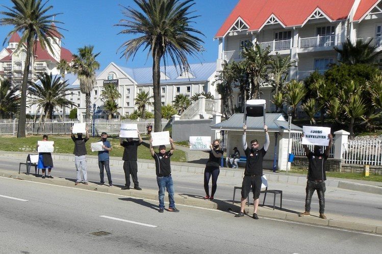 Empty chairs were placed along Marine Drive in Port Elizabeth and restaurant workers waved placards. Photo: Joseph Chirume