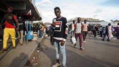 Artist Kudakwashe Chigodo poses for a portrait with his smartphone in Harare. Jekesai Njikizana/AFP/Getty Images.