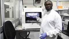 Professor Christian Happi, director of the African Centre of Excellence for Genomics of Infectious Diseases, displays one of the most advanced automated acid extractors being used in the laboratory. Pius Utomi Ekpei/AFP via Getty Images
