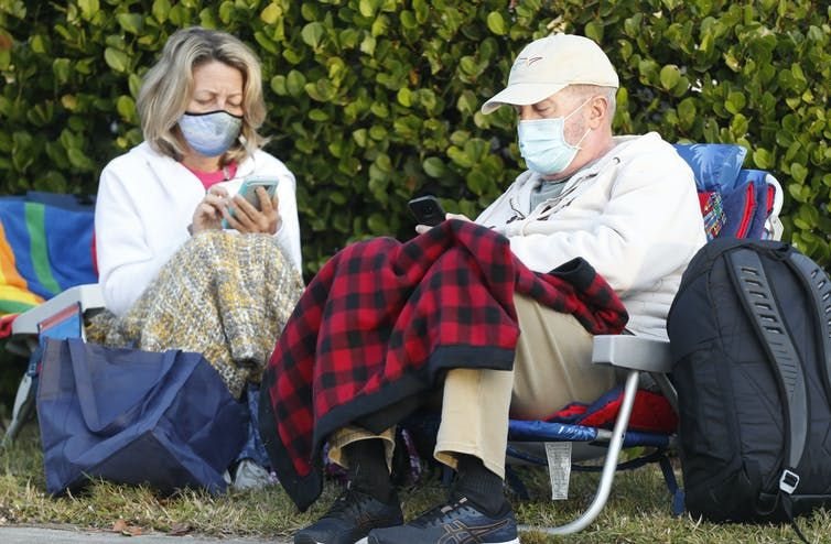 Seniors in Fort Myers, Fla. wait for their Covid-19 vaccinations. At this site, 800 doses of vaccine were available.