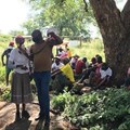 Mosadi Kwele speaks at a community meeting held on 19 January 2020, while Itumeleng Nyaka holds the megaphone. Like many others at the meeting, Kwele says Ikwezi Vanadium must respond to the community’s queries before continuing with mining activities at Haakdoornfontein farm. Photo: Masego Mafata