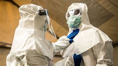Medical staff check each others protective suits. Photo by SUMY SADURNI/AFP via Getty Images