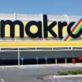 A worker walks beneath a logo at Makro Store Riversands of South African retailer Massmart in Midrand, South Africa, August 28, 2019. Reuters/Siphiwe Sibeko/File Photo