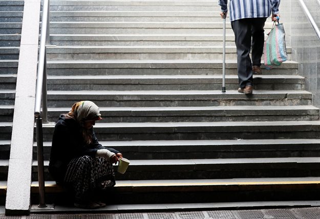 An elderly woman begs for money in an underpass in central Kyiv, Ukraine. Reuters/Gleb Garanich