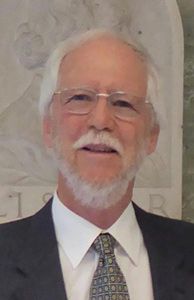 Prof. Don Kurtz receives a welcoming gift from the NWU Mascot, Eagie, at the Mahikeng Astronomical Observatory Telescope.