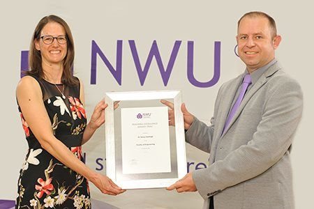 Dr Teresa Hattingh receives her reward from Prof Marco Le Roux, director of the Centre for Engineering Education