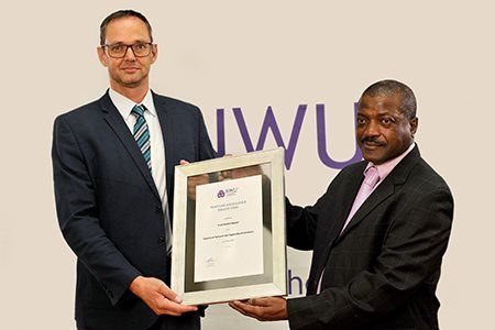 Prof Roelof Burger receives his award from Prof David Modise,<p>executive dean of the Faculty Natural and Agricultural Sciences.