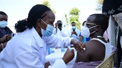 A healthcare worker administers an Oxford/AstraZeneca Covid-19 vaccine to her colleague at Mutuini Hospital in Nairobi. Kenya on March 3, 2021. Photo by Dennis Sigwe/SOPA Images/LightRocket via Getty Images