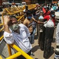 Family members of Covid-19 infected patients stand in a queue with empty oxygen cylinders outside the oxygen filling centre in New Delhi, India. Photo by Naveen Sharma/SOPA Images/LightRocket via Getty Images
